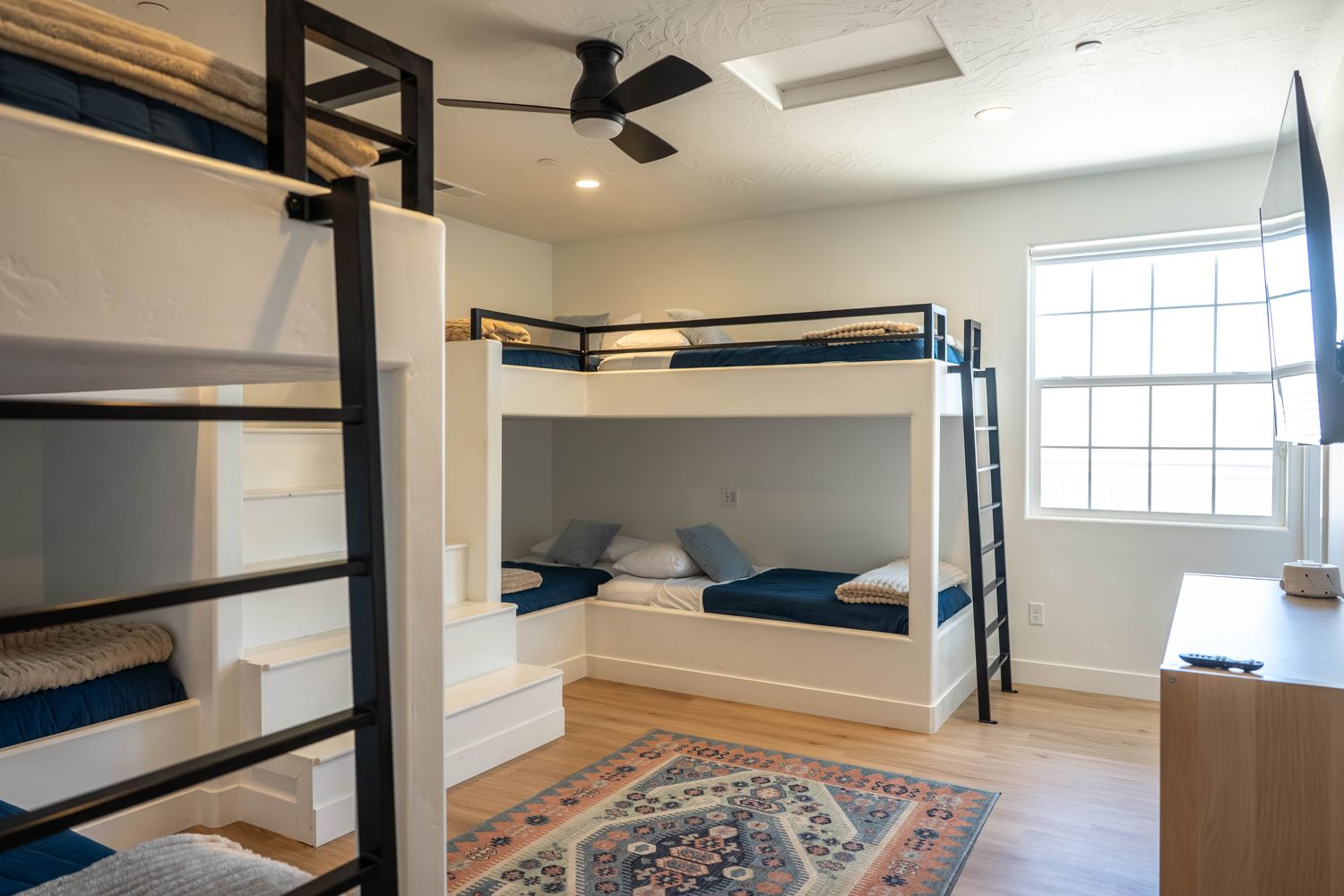 Bunk room with built-in bunk beds and navy bedding