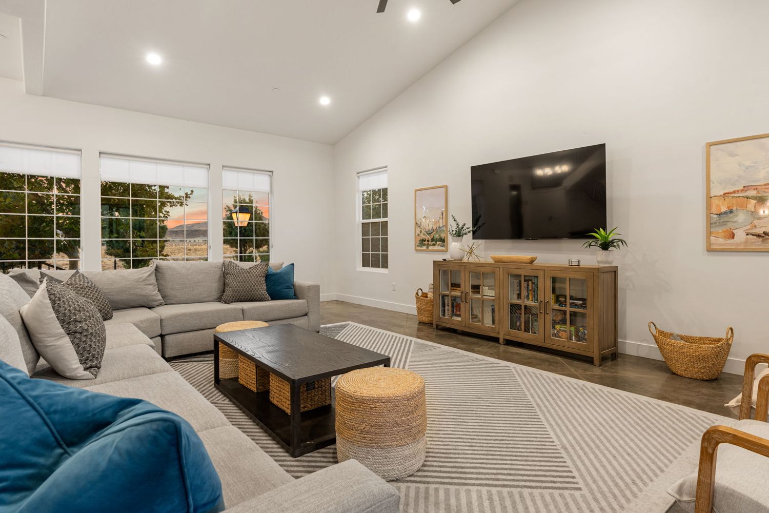 Bright open living room with a large sectional and windows