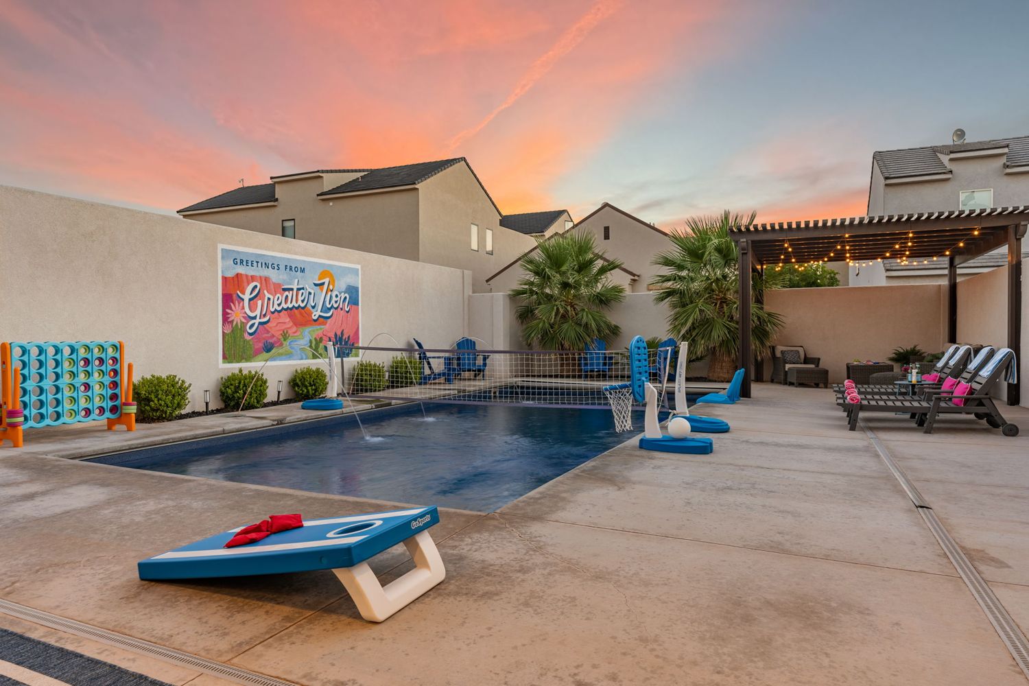 Pool and cornhole boards at dusk